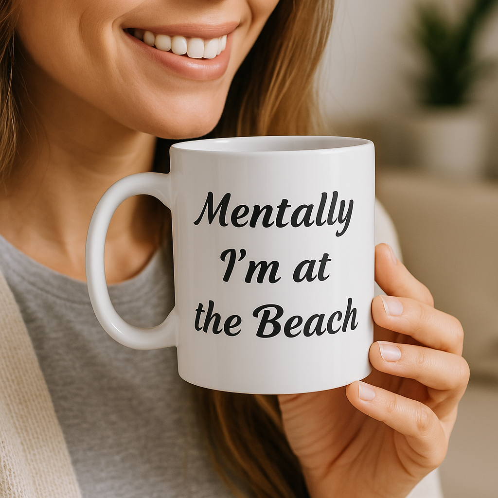 Person holding a white mug with 'Mentally I'm at the Beach' text