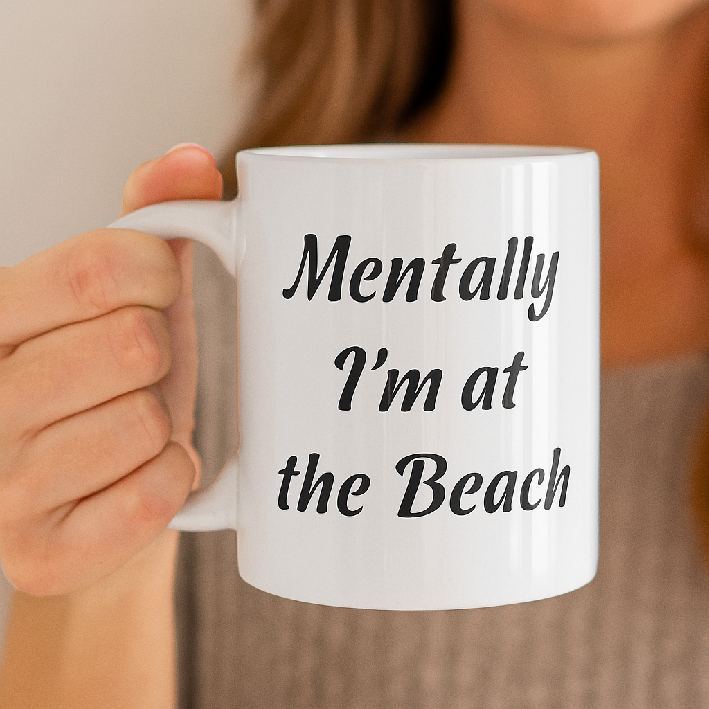 Person holding a mug with 'Mentally I'm at the Beach' text